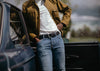 black belt with jeans outside vintage car