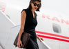 model walking with leather laptop sleeve